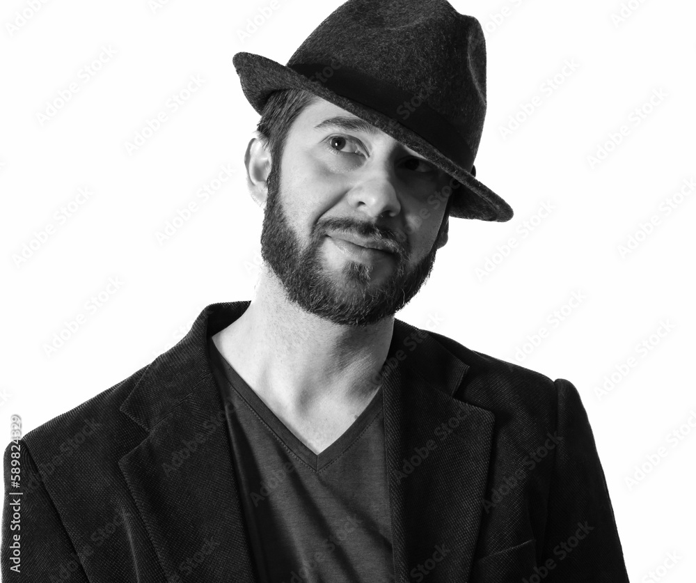 Grayscale shot of a handsome bearded male wearing a Fedora hat Grayscale shot of a handsome bearded male wearing a Fedora hat
