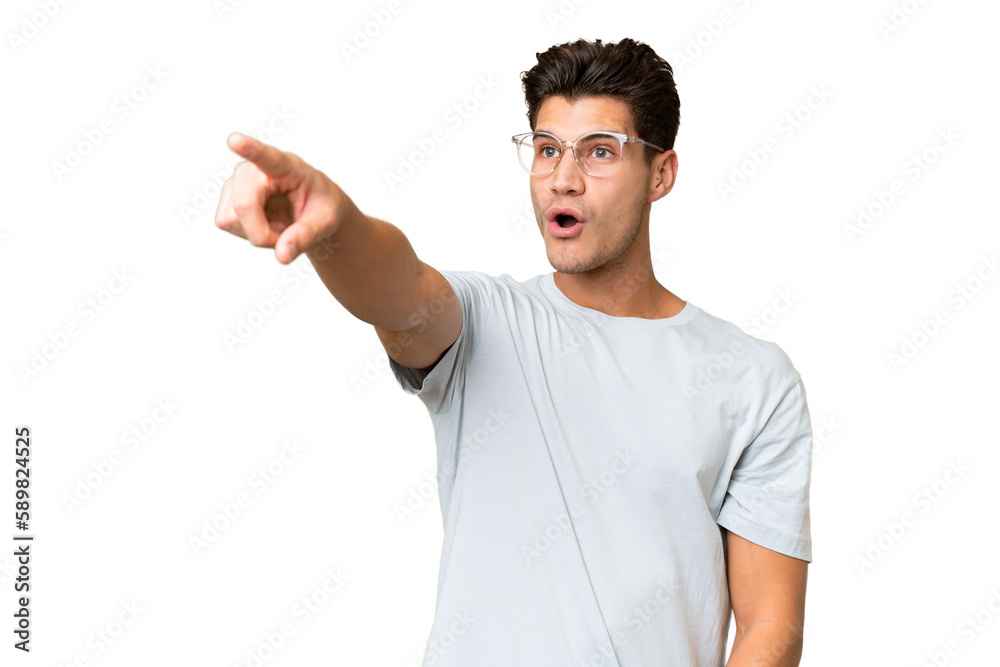 Young caucasian handsome man over isolated background pointing away Young caucasian handsome man over isolated background pointing away