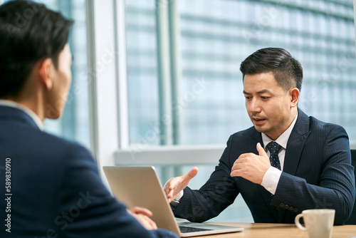 Obraz na plátně asian corporate executives discussing business in office