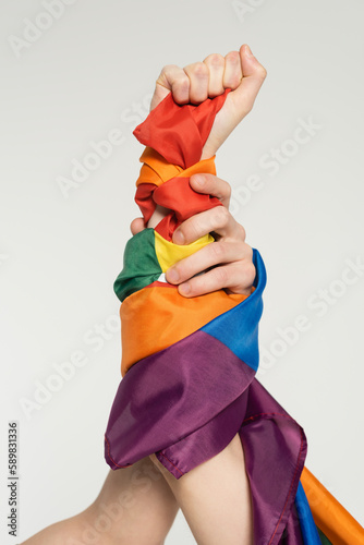 Konstfotografi partial view of hands of nonbinary couple with lgbt flag isolated on grey