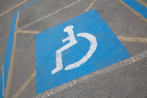 Obraz na płótnie Closeup of Blue Disabled Parking Space Sign on Slant w salonie
