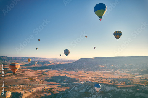 Lots of hot air balloons above fairy chimneys rock formations. Aerial view of Cappadocia. Goreme  Nevsehir province  Turkey