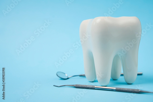 White healthy tooth  and dental tools for dentistry