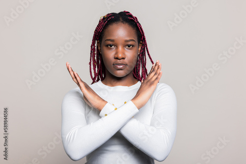 African American dark skinned woman over white background in studio isolated say now and cross her hands wearing casual white shirt posing while shooting process. photo