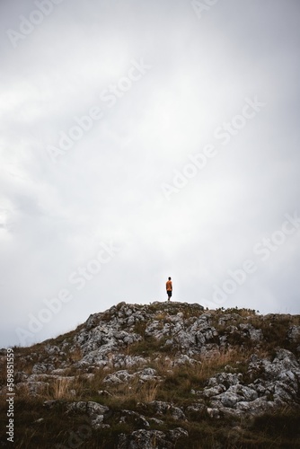 Vertical shot of a man standing at the top of the Durmitor mountain in Zabljak  Montenegro