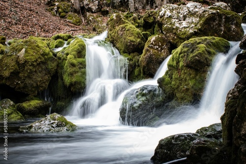 Closeup shot of a beautiful waterfall flowing in the forest in Serbia © Shadowhunter/Wirestock Creators