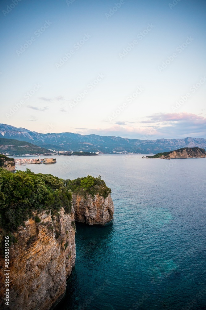 Vertical shot of the amazing Budva seaside in Montenegro with rocky cliffs