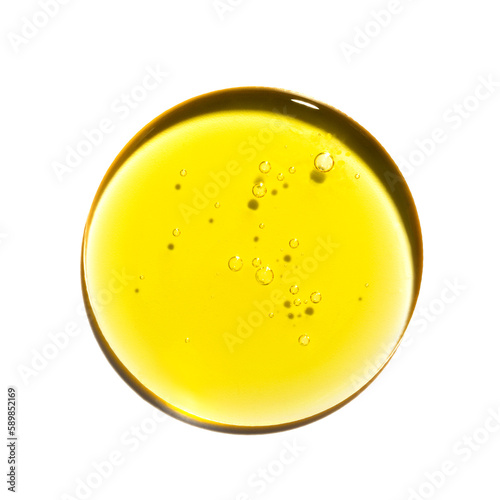 Drop of yellow oil swatch texture in petri dish macro with bubbles, cosmetics for face and body, science, laboratory isolated on white background