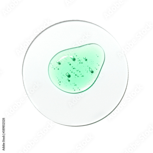 Texture swatch of green gel or oil on white isolated background, macro. Detergent, cosmetics, laboratory. A round drop in a petri dish
