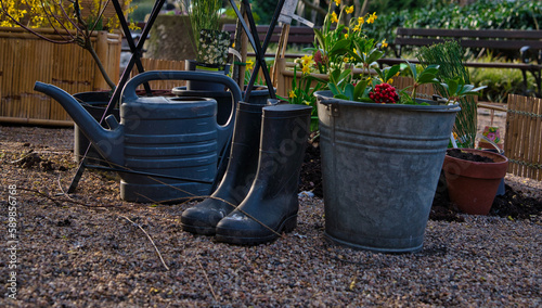 rain boots, bucket and watering can in the garden
