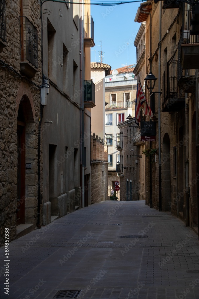 Narrow street with traditional residential buildings in old town of Solsona in province of Barcelona