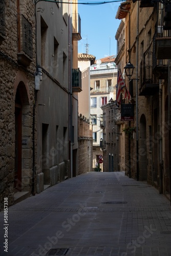 Narrow street with traditional residential buildings in old town of Solsona in province of Barcelona © Christian Rojo/Wirestock Creators