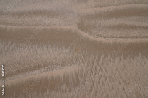 Sand painting, the surf of the Atlantic paints artistic structures in the sand.