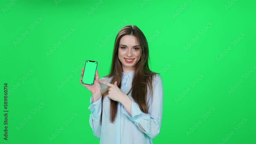 Shopping online, young woman in a shirt finds good products and makes a successful purchase online using a smartphone, a stylish woman on a green background. Shopping online, young woman in a shirt finds good products and makes a successful purchase online using a smartphone, a stylish woman on a green background.