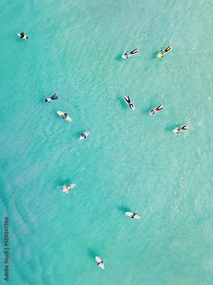 View from above, stunning aerial view of a person surfing on a turquoise ocean. Fuerteventura, Canary Islands, Spain.