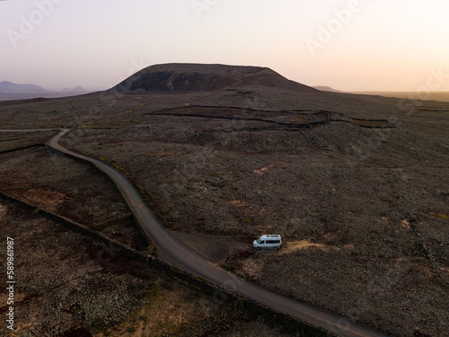 Obraz na płótnie View from above, stunning aerial view of a van parked under the Calderon Hondo in Fuerteventura, Canary Islands w salonie
