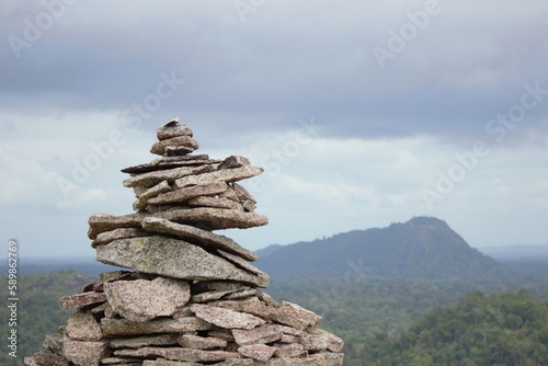 Canvas Print Cairn on the top of Voltzberg, Surinam with rainforest and mountain in the background