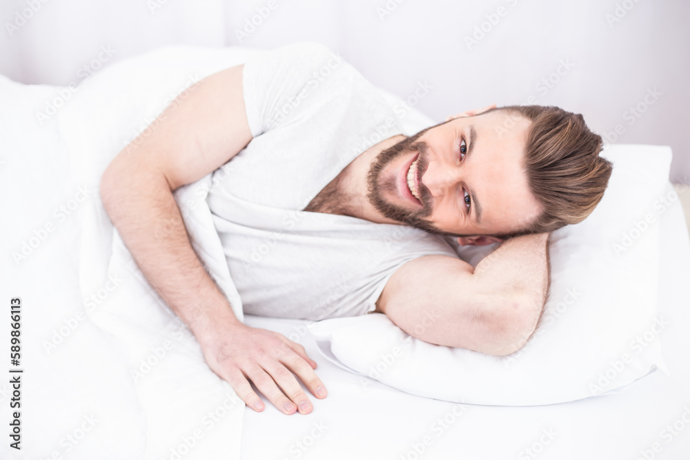 Bed and rest time. Tired millennial handsome bearded man asleep, resting peacefully in white comfortable bed in bedroom, copy space. Relax, sleep, nap at home on weekends. Bed and rest time. Tired millennial handsome bearded man asleep, resting peacefully in white comfortable bed in bedroom, copy space. Relax, sleep, nap at home on weekends.