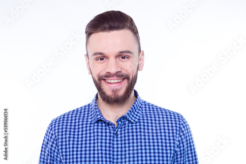 Strong, confident, handsome and bearded man in casual checkered shirt is posing isolated on white background with copy space for text and advertising