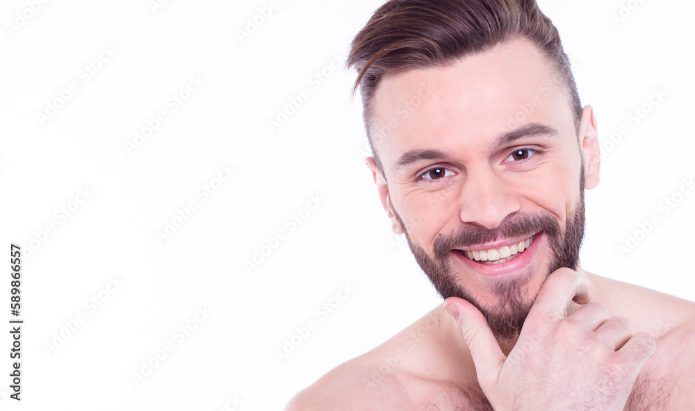 Obraz premium Handsome, attractive, brutal, modern, manly, confident, naked man touching his perfect, ideal face skin, looking at camera and posing isolated on white background after bath