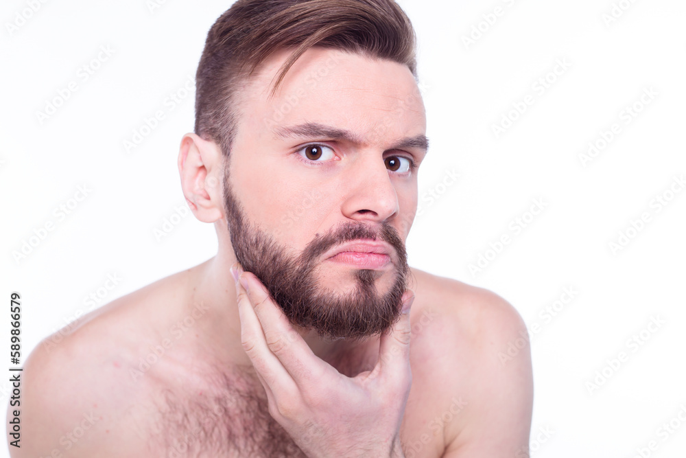 Handsome, attractive, brutal, modern, manly, confident, naked man touching his perfect, ideal face skin, looking at camera and posing isolated on white background after bath Handsome, attractive, brutal, modern, manly, confident, naked man touching his perfect, ideal face skin, looking at camera and posing isolated on white background after bath