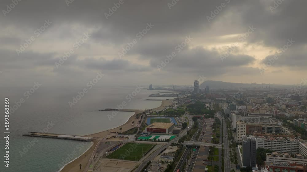 cloudy day barcelona city famous coastline traffic bay road aerial panorama 4k timelapse spain cloudy day barcelona city famous coastline traffic bay road aerial panorama 4k timelapse spain