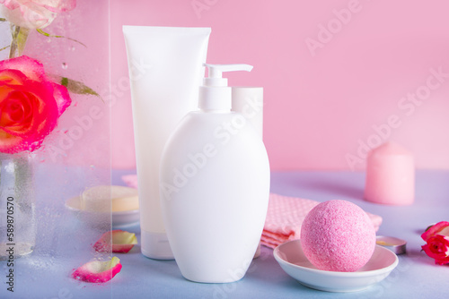 Blank mock up bottles beauty cosmetic skin care organic product for bathing routine with rose flower and petals. Place your design.