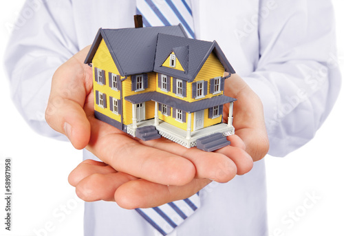 Building, mortgage, real estate and property concept - close up of hands holding house model