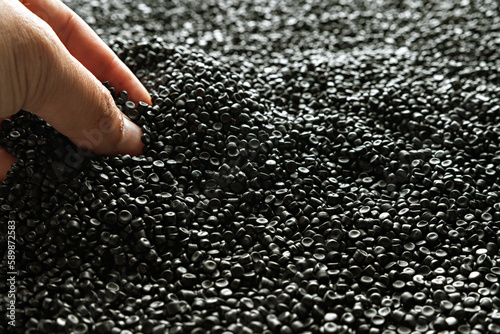 Small pieces of crushed plastic. Crushed bottle caps for recycling. Plastic waste that will be mixed with plastic vergin. Concept reducing plastic. photo