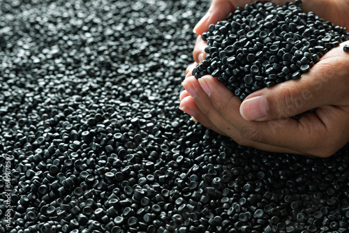 Small pieces of crushed plastic. Crushed bottle caps for recycling. Plastic waste that will be mixed with plastic vergin. Concept reducing plastic. photo