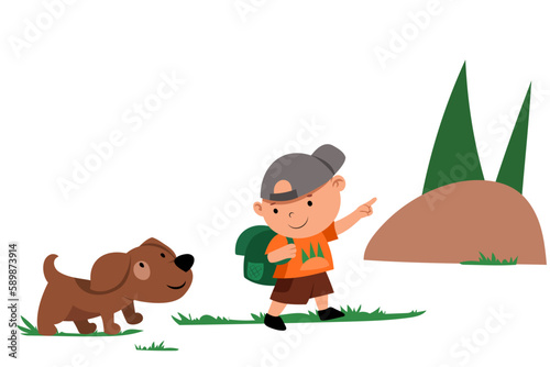 A boy with a puppy and a backpack go hiking up the mountain in the forest. The boy is talking to the dog, showing the direction with his hand.