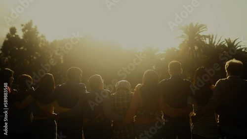 Multigenerational people having fun in a public park during sunset time