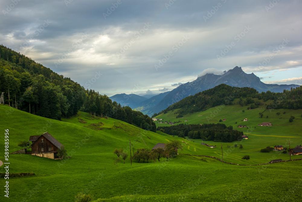 Green hills and farm buildings near the Buergenstock in the countryside of Lucerne in Switzerland