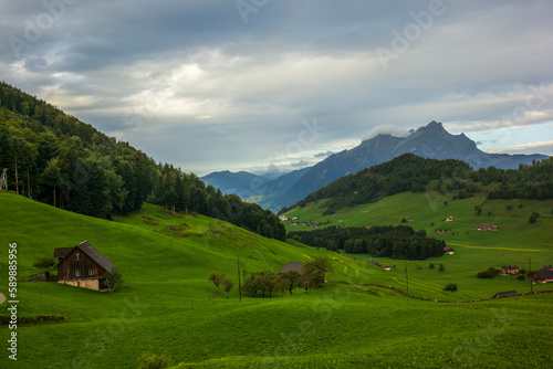 Green hills and farm buildings near the Buergenstock in the countryside of Lucerne in Switzerland © gdefilip