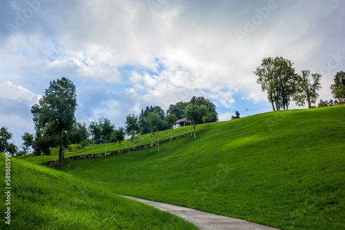 Green hills and farm buildings near the Buergenstock in the countryside of Lucerne in Switzerland © gdefilip