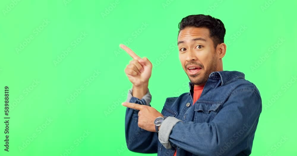 Asian man, pointing and dancing on green screen for advertising or marketing against a studio background. Portrait of happy male showing advertisement, gesture or point to product placement on mockup Asian man, pointing and dancing on green screen for advertising or marketing against a studio background. Portrait of happy male showing advertisement, gesture or point to product placement on mockup
