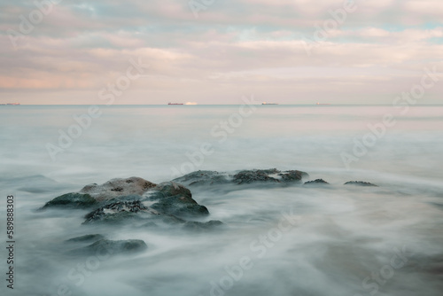 Long exposure of a sunset by the sea and a rocky coast © harry