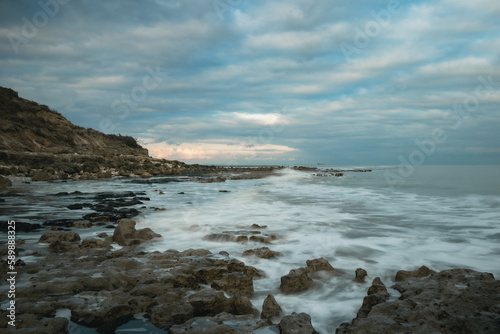 Long exposure shot of waves washing onto a rocky shore