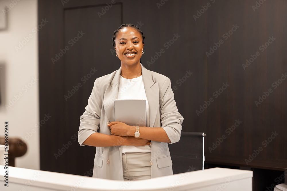 The young African American female receptionist stands behind the