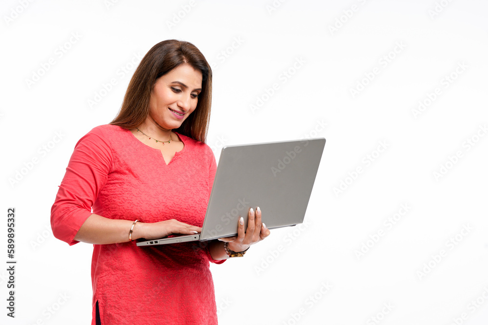 Young indian woman using laptop on white background. Young indian woman using laptop on white background.