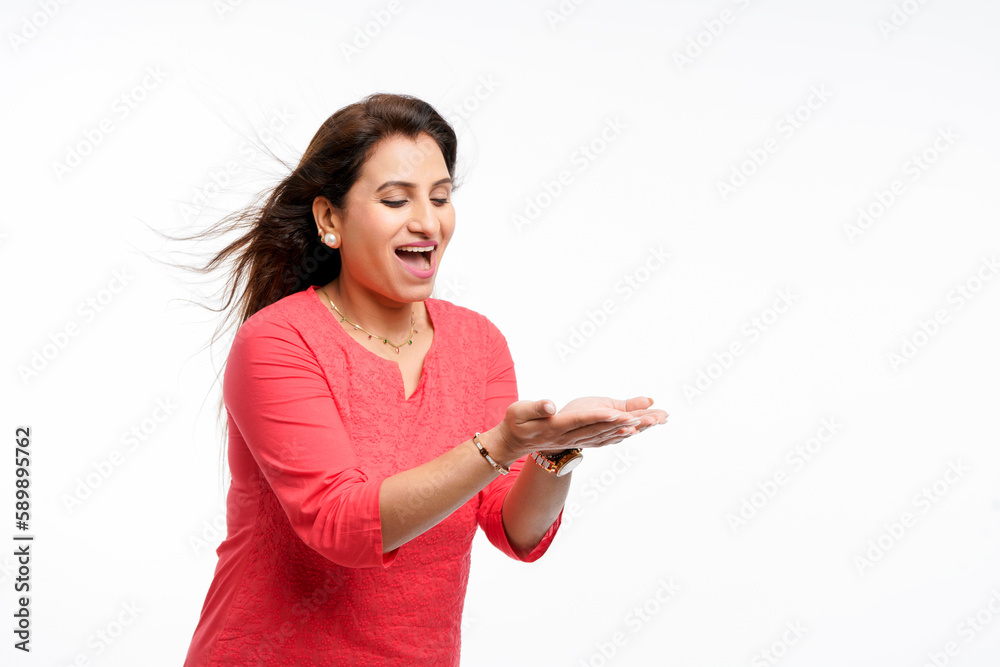 Indian woman raised empty hands or palm, holding copy space hand on white background. Indian woman raised empty hands or palm, holding copy space hand on white background.