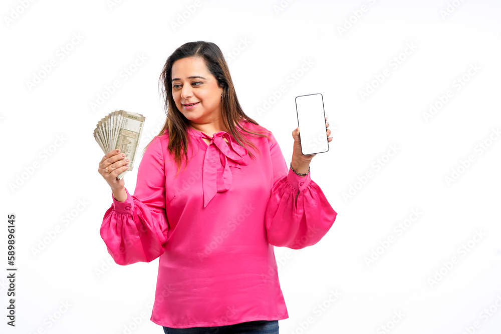 Indian woman showing smartphone screen and five hundred bank notes on white background. Indian woman showing smartphone screen and five hundred bank notes on white background.