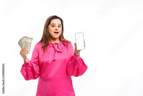 Indian woman showing smartphone screen and five hundred bank notes on white background. photo