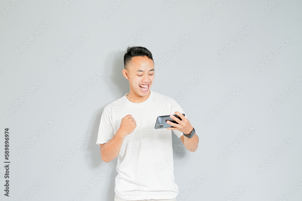 a young Asian is happy when he wins the game a young Asian is happy when he wins the game