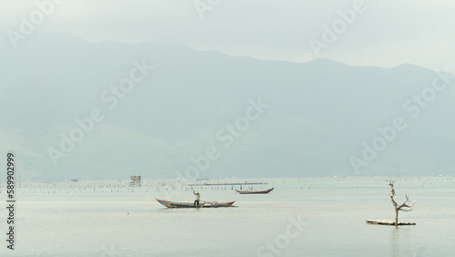Fishing boat, snag, river and sky one background
