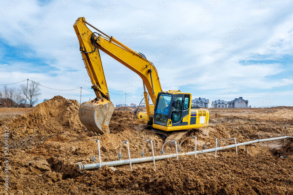 Excavator dig the trenches at a construction site. Trench for laying external sewer pipes. Sewage drainage system for a multi-story building. Digging the pit foundation Excavator dig the trenches at a construction site. Trench for laying external sewer pipes. Sewage drainage system for a multi-story building. Digging the pit foundation