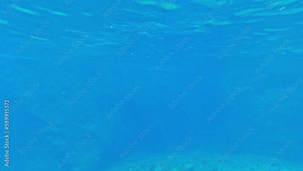 blue water with stones on the bottom blue water with stones on the bottom