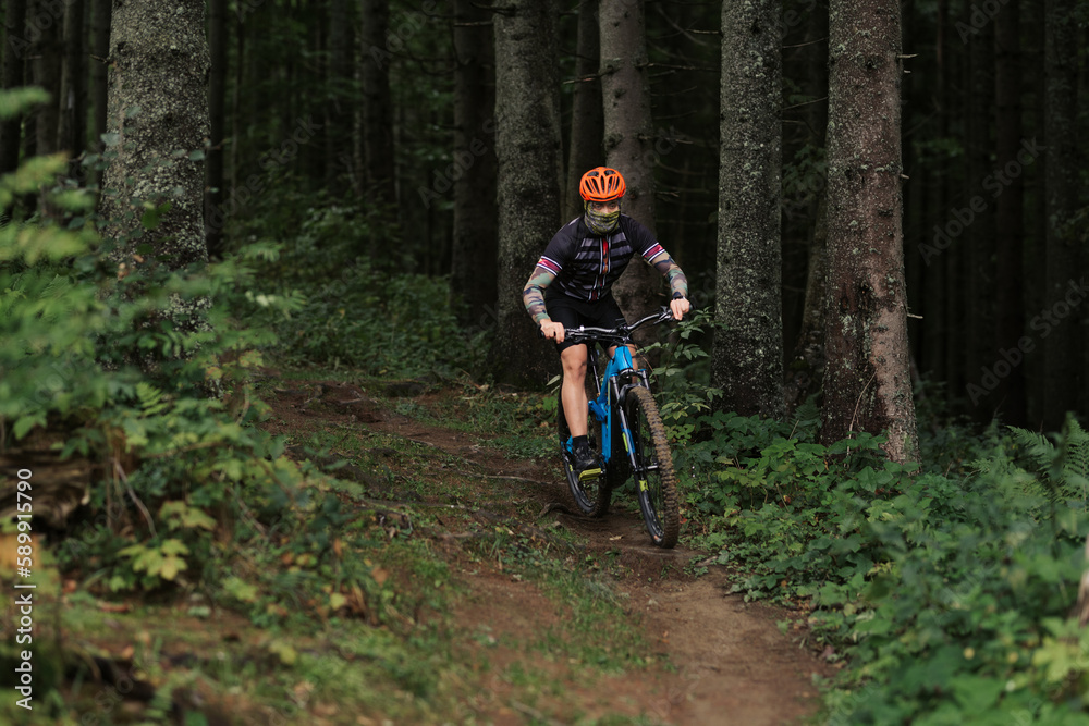 A cyclist rides a bicycle. Down the hill. A cyclist rides a bicycle. Down the hill.