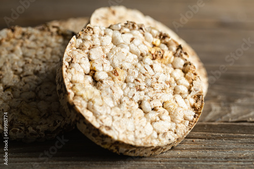 Close-up, rice cakes on wooden background. Tasty crisps, snack with health benefits.