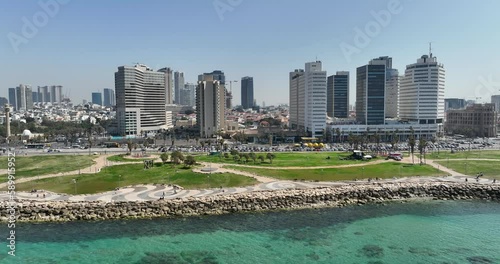 Aerial footage Tel Aviv beach promenade with the line of hotels in the background. Filmed in C4K Apple ProRes 422 HQ